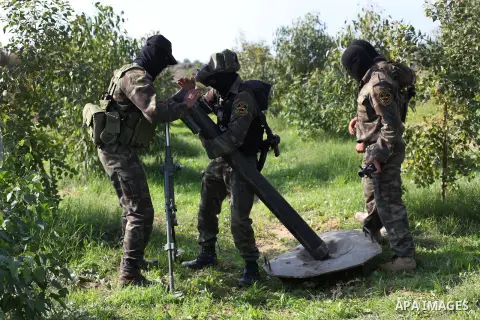 Palestinian militants from al-Quds Brigades the armed wing of the Islamic Jihad organization, stand around a rocket launcher during military exercises at an undisclosed location in the Hamas-run Gaza Strip in Gaza city o...