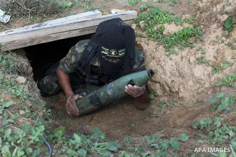 A Palestinian militant from al-Quds Brigades the armed wing of the Islamic Jihad organization, carries a rocket during military exercises at an undisclosed location in the Hamas-run Gaza Strip in Gaza city on Dec 16. 201...