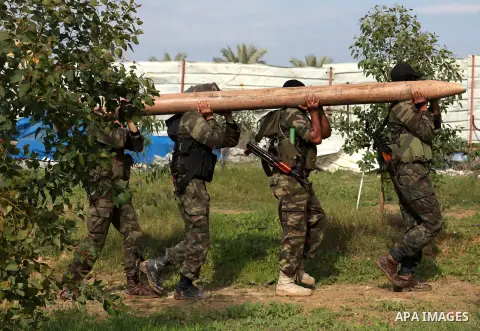 Palestinian militants from al-Quds Brigades the armed wing of the Islamic Jihad organization, carry a rocket during military exercises at an undisclosed location in the Hamas-run Gaza Strip in Gaza city on Dec 16. 2012....