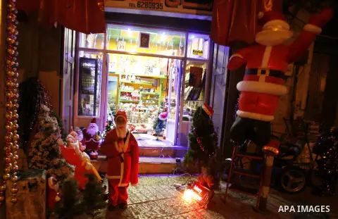 Palestinians dressed up as Santa Claus take part in a parade ahead of Christmas near Jerusalem's Old City December 16, 2012. Photo by Mahfouz Abu Turk