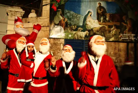 Palestinians dressed up as Santa Claus take part in a parade ahead of Christmas near Jerusalem's Old City December 16, 2012. Photo by Mahfouz Abu Turk