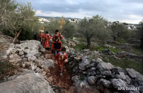 Palestinian Orthodox Christians return from the nearby ancient monastery of St. Barbara to the Palestinian village of Abud, in the Israeli occupied West Bank, during a parade to celebrate the annual festival of St. Barba...