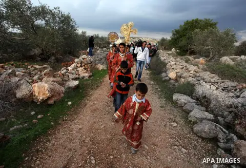 Palestinian Orthodox Christians return from the nearby ancient monastery of St. Barbara to the Palestinian village of Abud, in the Israeli occupied West Bank, during a parade to celebrate the annual festival of St. Barba...