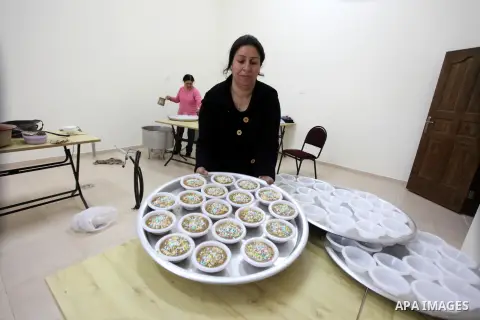 Palestinian women make traditional sweets to mark the annual festival of St. Barbara's Day in the Palestinian village of Abud, in the Israeli occupied West Bank on December 16, 2012. Photo by Issam Rimawi