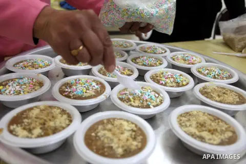 A Palestinian woman makes traditional sweets to mark the annual festival of St. Barbara's Day in the Palestinian village of Abud, in the Israeli occupied West Bank on December 16, 2012. Photo by Issam Rimawi