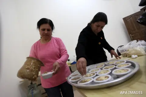 Palestinian women make traditional sweets to mark the annual festival of St. Barbara's Day in the Palestinian village of Abud, in the Israeli occupied West Bank on December 16, 2012. Photo by Issam Rimawi