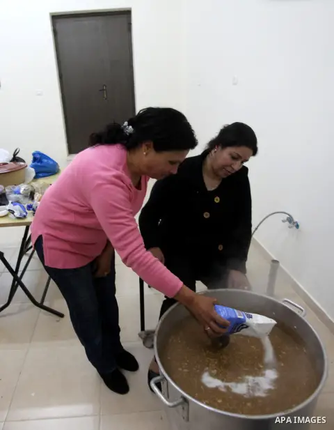 Palestinian women make traditional sweets to mark the annual festival of St. Barbara's Day in the Palestinian village of Abud, in the Israeli occupied West Bank on December 16, 2012. Photo by Issam Rimawi
