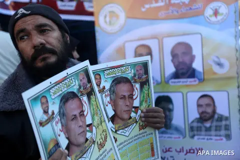 Palestinians hold pictures of their prisoner relatives in Israeli jails as they gather in a weekly activity calling for their liberty at the Red Cross headquarters in Gaza city on December 17, 2012. Photo by Majdi Fathi