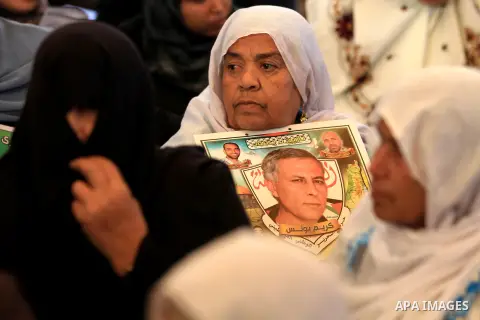 Palestinians hold pictures of their prisoner relatives in Israeli jails as they gather in a weekly activity calling for their liberty at the Red Cross headquarters in Gaza city on December 17, 2012. Photo by Majdi Fathi
