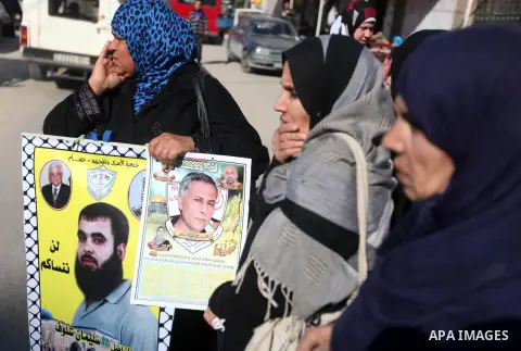 Palestinians hold pictures of their prisoner relatives in Israeli jails as they gather in a weekly activity calling for their liberty at the Red Cross headquarters in Gaza city on December 17, 2012. Photo by Majdi Fathi