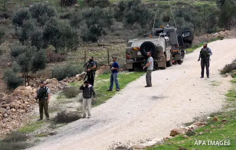 Israeli soldiers stand as Jewish settlers hurl stones during clashes with Palestinians, not seen, outside the West Bank village of Madama and the Jewish settlement of Yitzhar, near Nablus, Dec. 17, 2012. Photo by Nedal E...