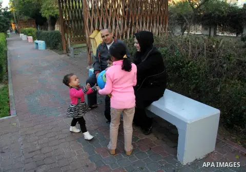 A Palestinian woman, Samar Bulbul plays with her kids at a park in Gaza city on Dec. 18,2012. Bulbul lost hearing after an Israeli airstrike targeted two Palestinian militants' car in Gaza city in December 2011. Photo by...