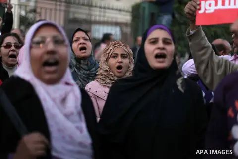 Egyptian protesters shout slogans against the President Mohamed Morsi and hold a banner reading in Arabic 'no to the constitution' during a demonstration against the draft constitution, in Cairo, Egypt, 18 December 2012....
