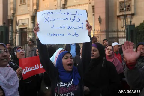 Egyptian protesters shout slogans against the President Mohamed Morsi and hold a banner reading in Arabic 'no to the constitution' during a demonstration against the draft constitution, in Cairo, Egypt, 18 December 2012....