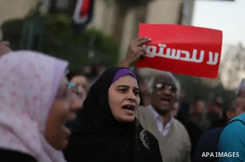 Egyptian protesters shout slogans against the President Mohamed Morsi and hold a banner reading in Arabic 'no to the constitution' during a demonstration against the draft constitution, in Cairo, Egypt, 18 December 2012....