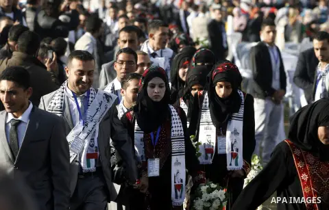 Palestinian brides and grooms pose during a mass wedding ceremony in Rafah southern Gaza strip, on December 19, 2012. The mass wedding organized by National Islamic Committee and funding by the institution of Sheikh Khal...