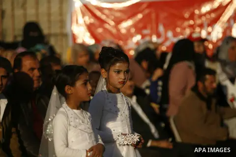 Palestinians attend a mass wedding ceremony in Rafah southern Gaza strip, on December 19, 2012. The mass wedding organized by National Islamic Committee and funding by the institution of Sheikh Khalifa bin Zayed bin Al N...