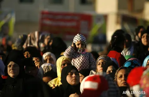 Palestinians attend a mass wedding ceremony in Rafah southern Gaza strip, on December 19, 2012. The mass wedding organized by National Islamic Committee and funding by the institution of Sheikh Khalifa bin Zayed bin Al N...