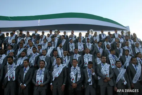 Palestinians grooms pose during a mass wedding ceremony in Rafah southern Gaza strip, on December 19, 2012. The mass wedding organized by National Islamic Committee and funding by the institution of Sheikh Khalifa bin Za...