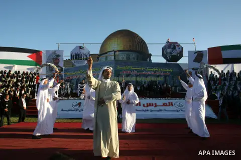 Palestinians perform traditional dance during a mass wedding ceremony in Rafah southern Gaza strip, on December 19, 2012. The mass wedding organized by National Islamic Committee and funding by the institution of Sheikh...