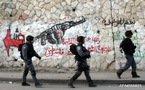 Israeli soldiers walk during clashes with Palestinians in the Arab Jerusalem neighbourhood of Issawiya after a demonstration in solidarity with Palestinian prisoner Samer Issawi, held in an Israeli jail and on hunger str...
