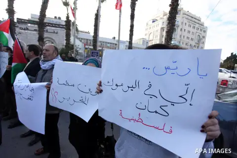 Palestinians hold placards during a protest in solidarity with Palestinian in al-Yarmouk refugee camp in Syria in the West Bank city of Ramallah on 19 December 2012. Pro-rebel sources reported that at least 25 Palestinia...