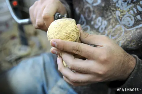 A Palestinian carpenter carves a wooden sculpture of baby Jesus at a workshop in the West Bank town of Bethlehem, on December 20, 2012. The traditional birthplace of Jesus Christ prepares to celebrate Christmas later thi...