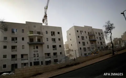 Labourers work at the construction site of a new housing project at the Jewish settlement of Kiryat Moreh in south Jerusalem on December 20, 2012. Israel has approved plans to build 523 homes in the West Bank, Jewish set...
