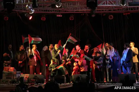 Palestinian Prime Minister in Gaza strip Ismail Haniyeh, Share with Members of the Birds of Paradise team sing during an Islamic song festival in Gaza City on December 20, 2012. Photo by Ezz Zanoun