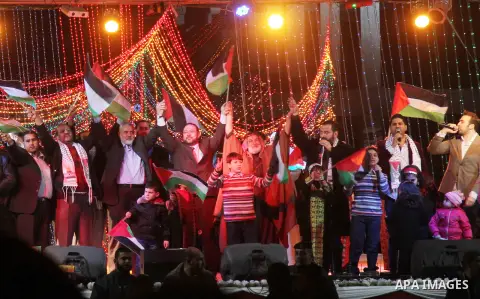 Palestinian Prime Minister in Gaza strip Ismail Haniyeh, Share with Members of the Birds of Paradise team sing during an Islamic song festival in Gaza City on December 20, 2012. Photo by Ezz Zanoun