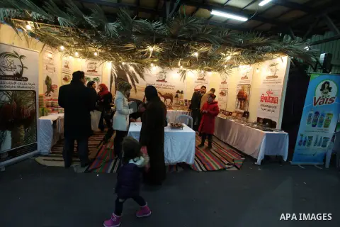 Palestinians attend the opening of the first winter shopping festival in the West Bank city of Ramallah, 21 December 2012. Photo by Issam Rimawi