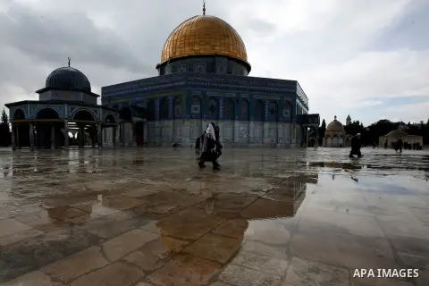 Palestinian worshippers walk in front of the Dome of the Rock mosque following Friday prayer at al-Aqsa mosque, Islam's third holiest site, in the old city of Jerusalem on December 21, 2012. Photo by Mahfouz Abu Turk