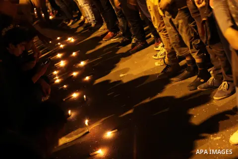 Egyptian protesters place candles as they gather at Tahrir square in Cairo, Egypt, Friday, Dec. 21, 2012. Running clashes between rival protesters erupted in Egypt's second city Alexandria, on the eve of the final round...