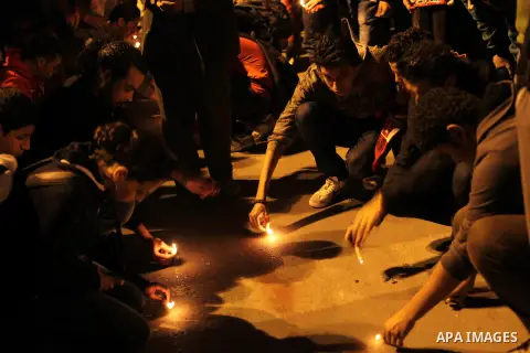 Egyptian protesters place candles as they gather at Tahrir square in Cairo, Egypt, Friday, Dec. 21, 2012. Running clashes between rival protesters erupted in Egypt's second city Alexandria, on the eve of the final round...