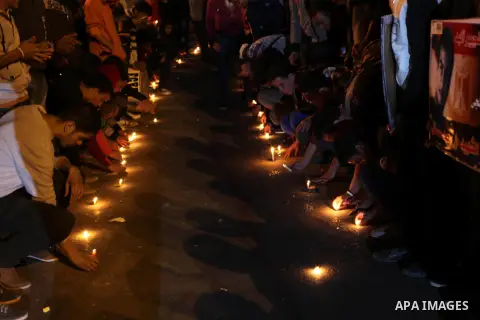 Egyptian protesters place candles as they gather at Tahrir square in Cairo, Egypt, Friday, Dec. 21, 2012. Running clashes between rival protesters erupted in Egypt's second city Alexandria, on the eve of the final round...