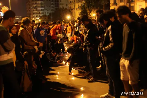Egyptian protesters place candles as they gather at Tahrir square in Cairo, Egypt, Friday, Dec. 21, 2012. Running clashes between rival protesters erupted in Egypt's second city Alexandria, on the eve of the final round...