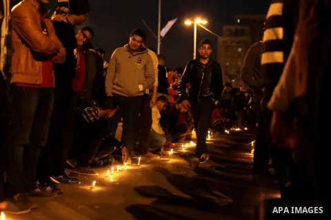 Egyptian protesters place candles as they gather at Tahrir square in Cairo, Egypt, Friday, Dec. 21, 2012. Running clashes between rival protesters erupted in Egypt's second city Alexandria, on the eve of the final round...