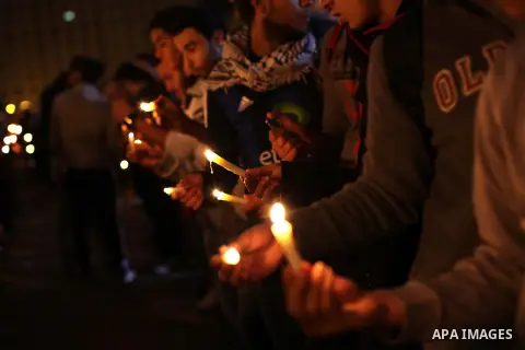 Egyptian protesters hold candles as they gather at Tahrir square in Cairo, Egypt, Friday, Dec. 21, 2012. Running clashes between rival protesters erupted in Egypt's second city Alexandria, on the eve of the final round o...