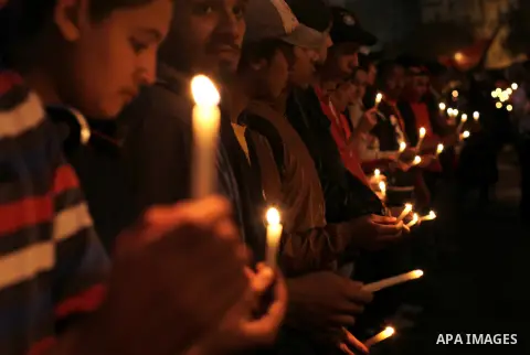 Egyptian protesters hold candles as they gather at Tahrir square in Cairo, Egypt, Friday, Dec. 21, 2012. Running clashes between rival protesters erupted in Egypt's second city Alexandria, on the eve of the final round o...