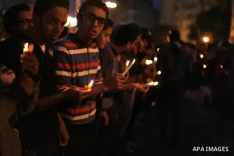 Egyptian protesters hold candles as they gather at Tahrir square in Cairo, Egypt, Friday, Dec. 21, 2012. Running clashes between rival protesters erupted in Egypt's second city Alexandria, on the eve of the final round o...