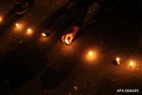 Egyptian protesters place candles as they gather at Tahrir square in Cairo, Egypt, Friday, Dec. 21, 2012. Running clashes between rival protesters erupted in Egypt's second city Alexandria, on the eve of the final round...