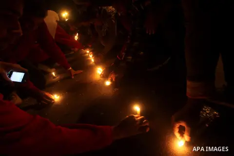 Egyptian protesters place candles as they gather at Tahrir square in Cairo, Egypt, Friday, Dec. 21, 2012. Running clashes between rival protesters erupted in Egypt's second city Alexandria, on the eve of the final round...