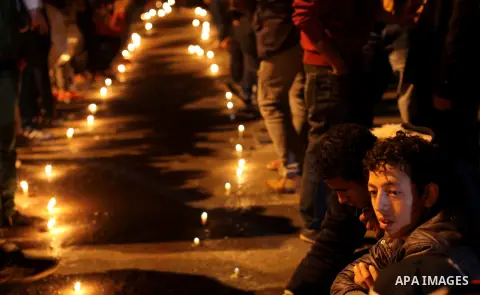 Egyptian protesters place candles as they gather at Tahrir square in Cairo, Egypt, Friday, Dec. 21, 2012. Running clashes between rival protesters erupted in Egypt's second city Alexandria, on the eve of the final round...