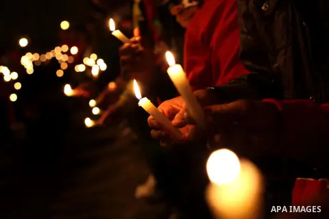 Egyptian protesters hold candles as they gather at Tahrir square in Cairo, Egypt, Friday, Dec. 21, 2012. Running clashes between rival protesters erupted in Egypt's second city Alexandria, on the eve of the final round o...