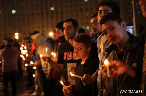 Egyptian protesters hold candles as they gather at Tahrir square in Cairo, Egypt, Friday, Dec. 21, 2012. Running clashes between rival protesters erupted in Egypt's second city Alexandria, on the eve of the final round o...