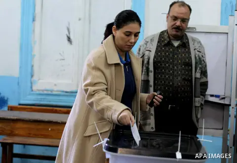 An Egyptian woman casts her ballot at a polling station during the second round of a referendum on a new draft constitution in Giza, south of Cairo, on December 22, 2012. Egyptians are voting in the final round of a refe...