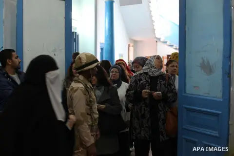 Egyptian women queue with other voters at a polling station during the second round of a referendum on a new draft constitution in Giza, south of Cairo, on December 22, 2012. Egyptians are voting in the final round of a...