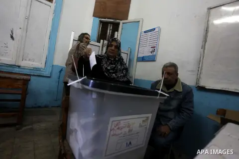 An Egyptian woman casts her ballot at a polling station during the second round of a referendum on a new draft constitution in Giza, south of Cairo, on December 22, 2012. Egyptians are voting in the final round of a refe...