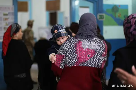 Egyptian women queue with other voters at a polling station during the second round of a referendum on a new draft constitution in Giza, south of Cairo, on December 22, 2012. Egyptians are voting in the final round of a...