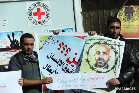 Palestinians who covered their eyes with black ribbons demonstrate in support of Palestinian prisoners held in Israeli jails, some of whom are observing a hunger strike, in Gaza City on December 22, 2012. Photo by Majdi...